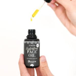 woman holding dropper of hydrating face oil