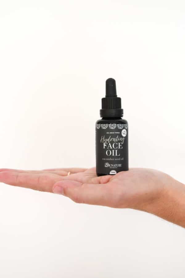 hydrating face oil held in hand