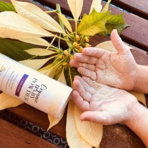 talc free baby powder on childs hands